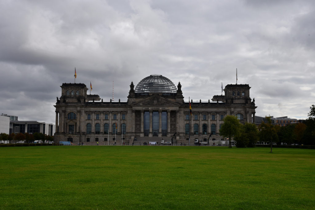 Gmach parlamentu Rzeszy a przed nim zielony trawiasty Plac Republiki